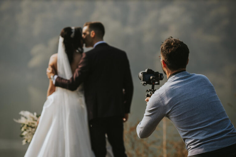 closeup shot photographer taking photo bride groom kissing each other